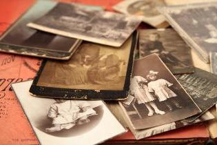 A stack of old sepia toned photographs.