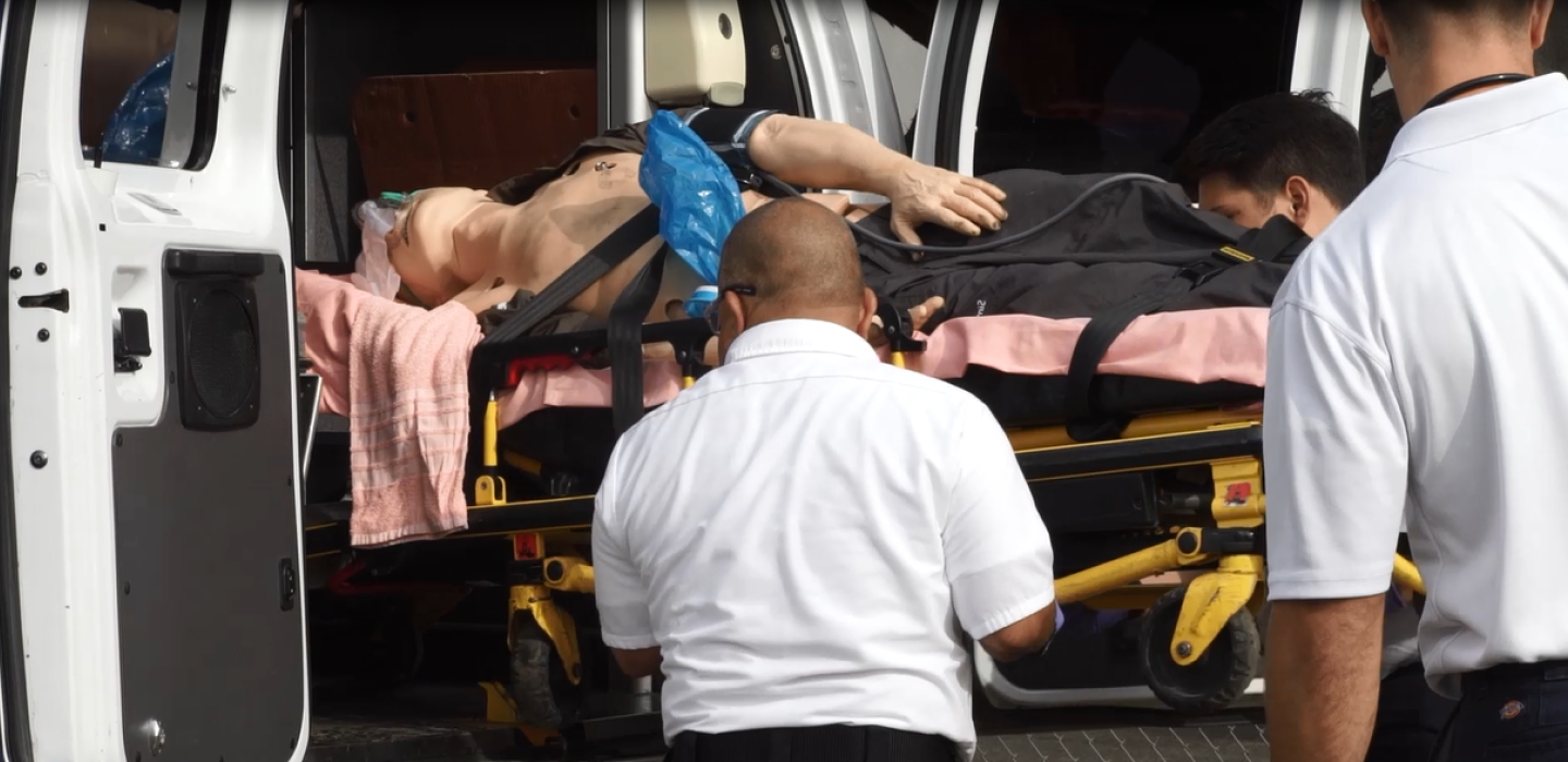 Ventura College EMT Students carry patient on a gurney into an ambulance 